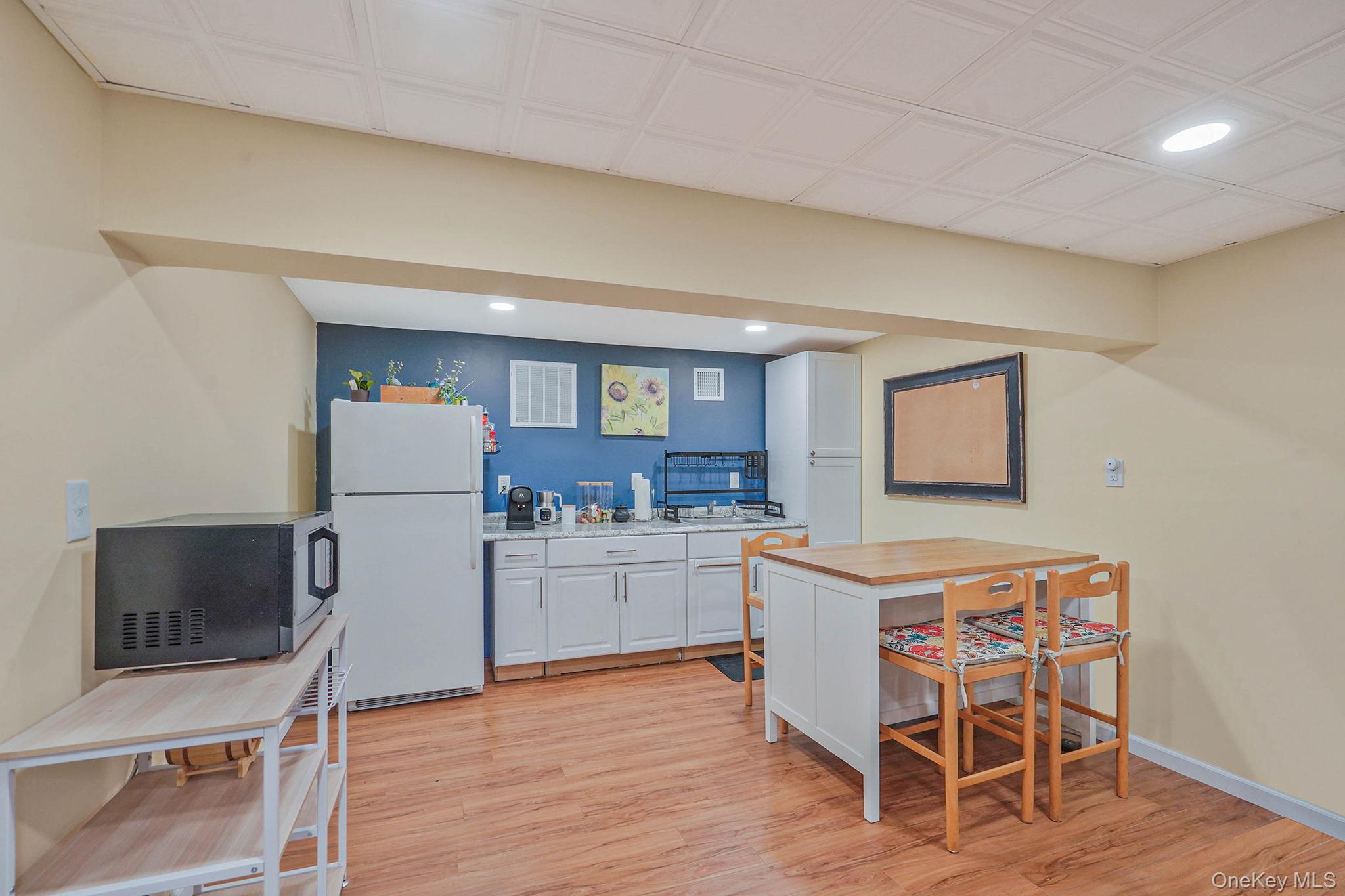 318 Sheep Pasture Road East Setauket, NY 11733 - Photo 31 of 45 a kitchen with stainless steel appliances a stove a sink cabinets and a dining table