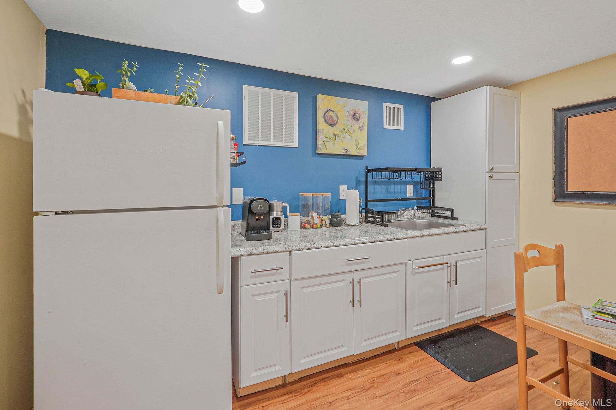 318 Sheep Pasture Road East Setauket, NY 11733 - Photo 32 of 45 a kitchen with stainless steel appliances granite countertop a refrigerator sink and cabinets