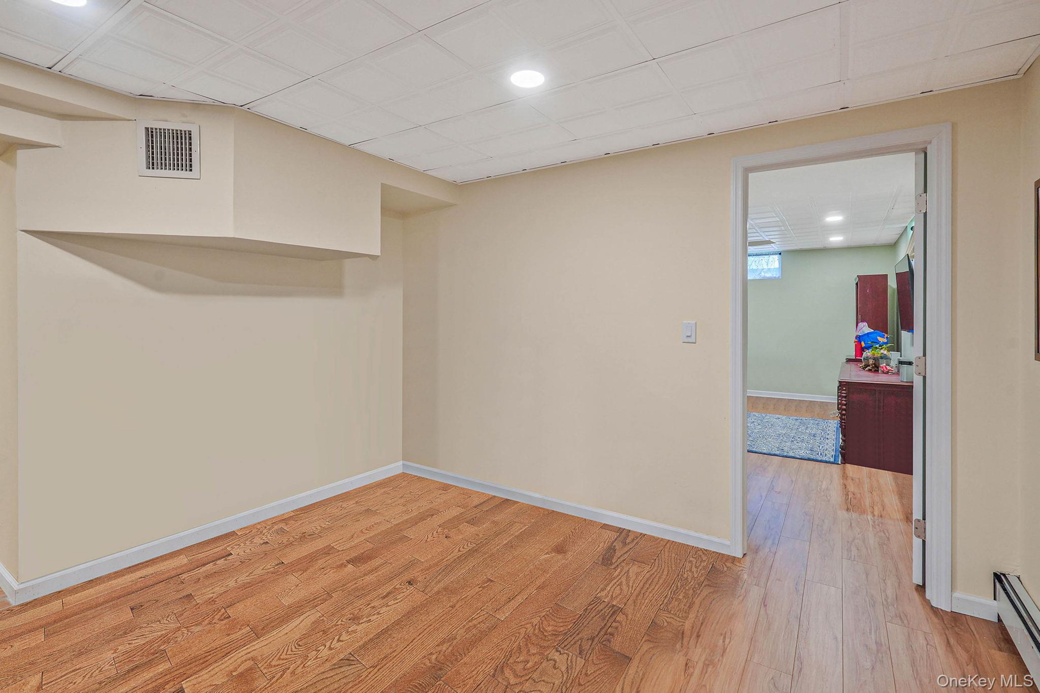 318 Sheep Pasture Road East Setauket, NY 11733 - Photo 35 of 45 a view of a room with wooden floor and a bathroom
