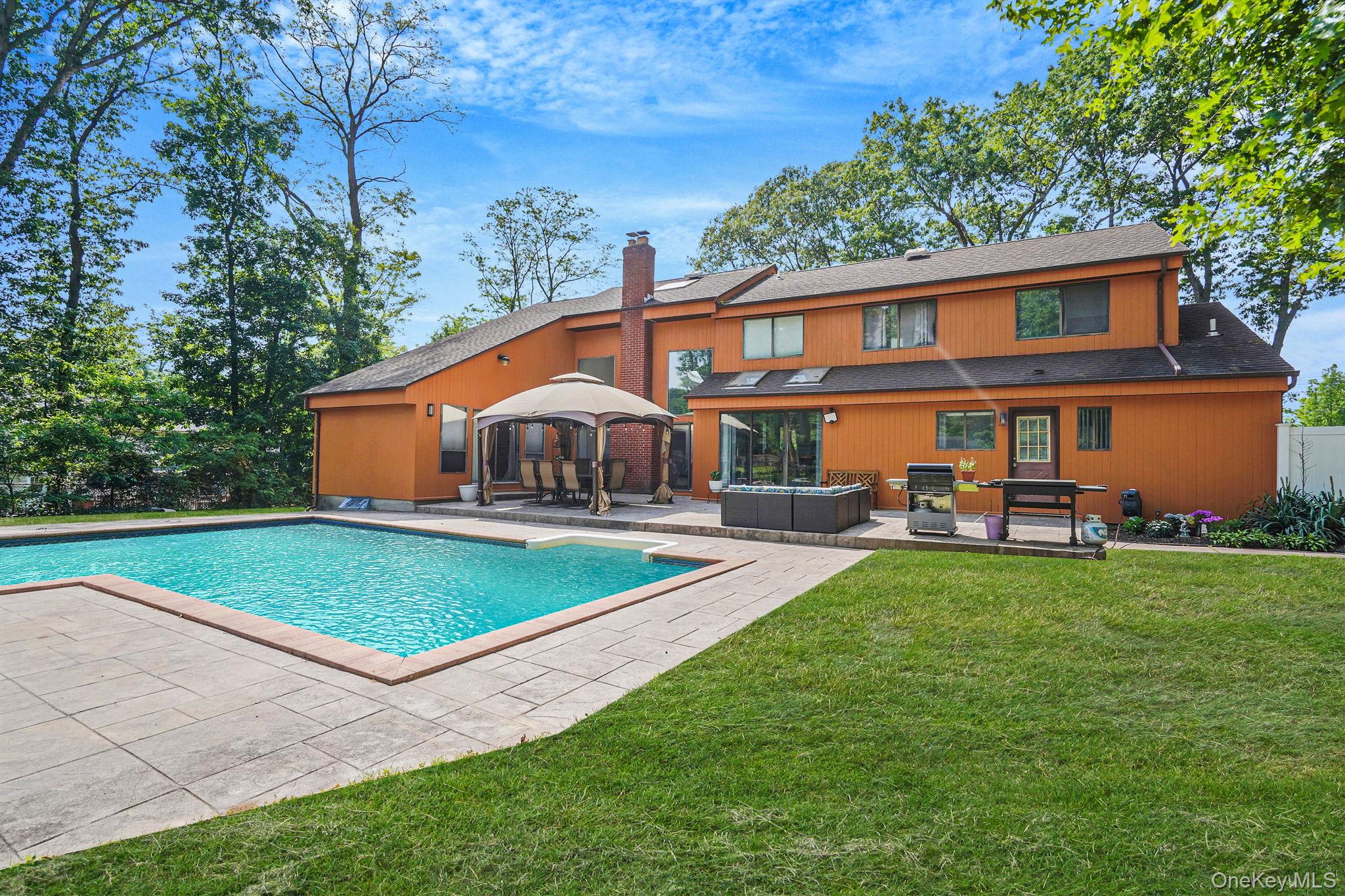 318 Sheep Pasture Road East Setauket, NY 11733 - Photo 40 of 45 a front view of house with yard and outdoor seating
