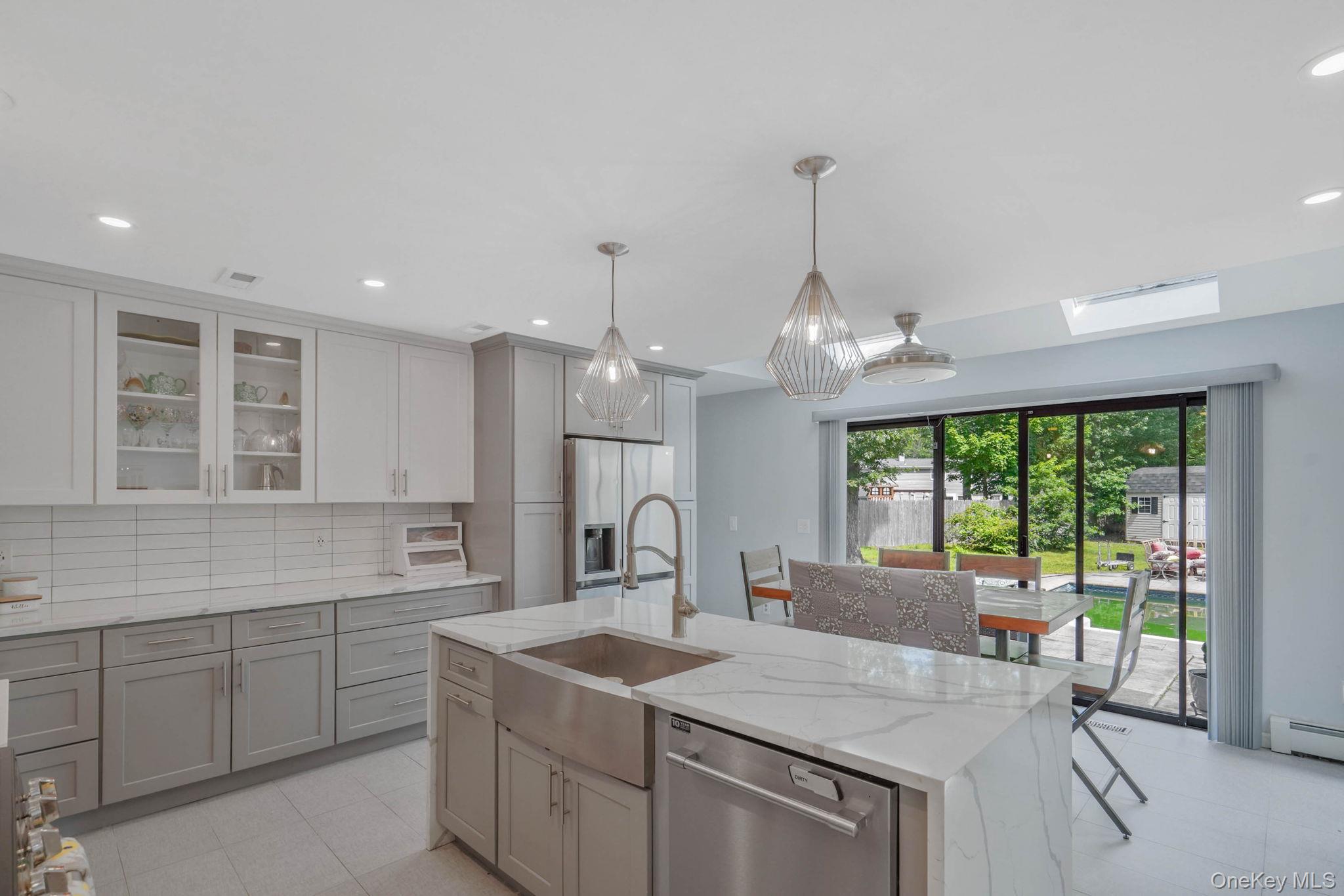 318 Sheep Pasture Road East Setauket, NY 11733 - Photo 6 of 45 a kitchen with center island and windows