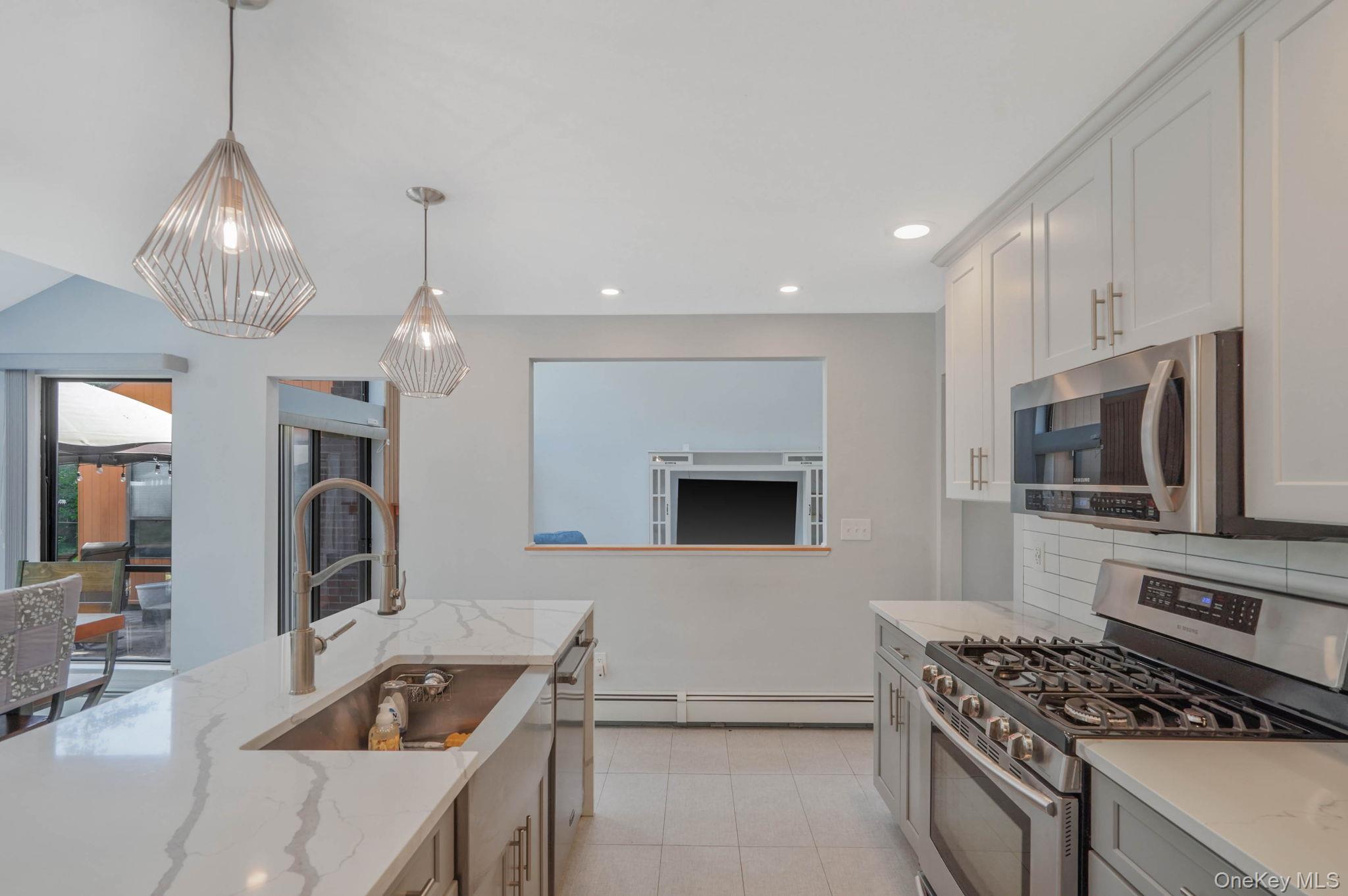 318 Sheep Pasture Road East Setauket, NY 11733 - Photo 8 of 45 a kitchen with granite countertop a stove and a sink