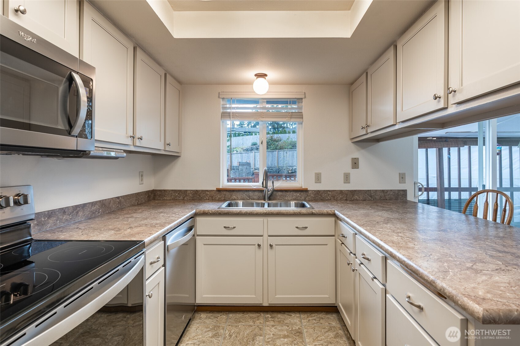 14031 33rd Place South Tukwila, WA 98168 - Photo 12 of 37 a kitchen with granite countertop a sink stove and cabinets