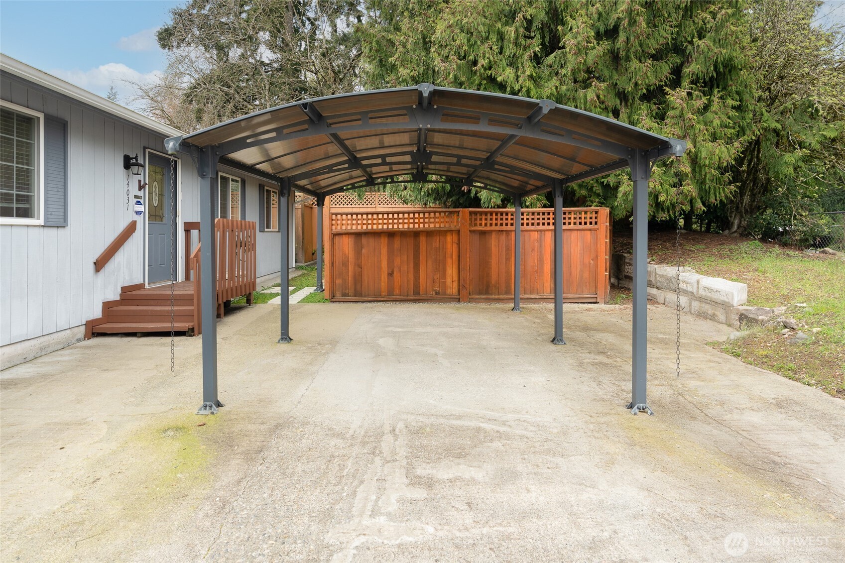 14031 33rd Place South Tukwila, WA 98168 - Photo 26 of 37 a patio with a table and chairs under an umbrella
