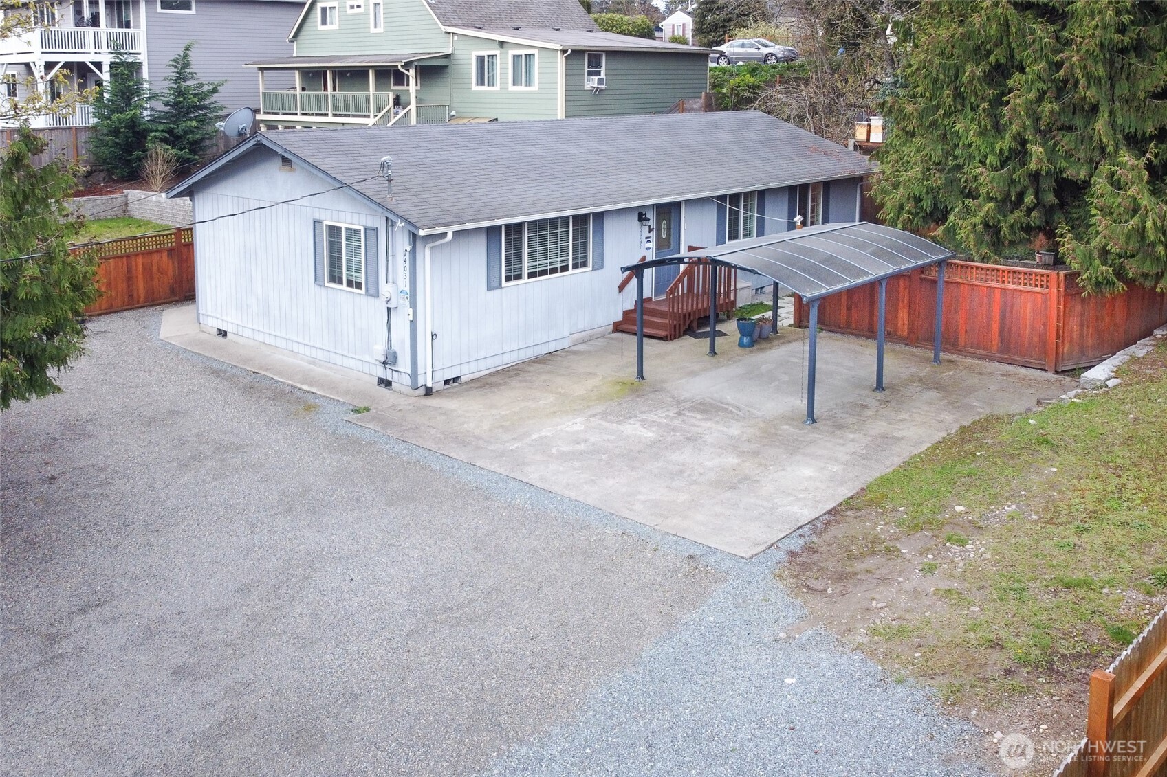 14031 33rd Place South Tukwila, WA 98168 - Photo 3 of 37 a view of a house with table and chairs under an umbrella