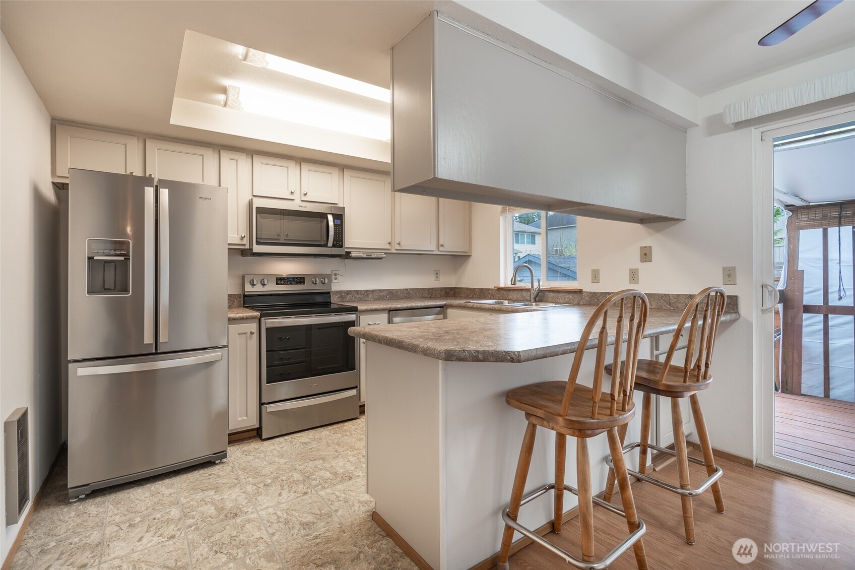 14031 33rd Place South Tukwila, WA 98168 - Photo 10 of 37 a kitchen with stainless steel appliances granite countertop a refrigerator a stove a sink and a microwave