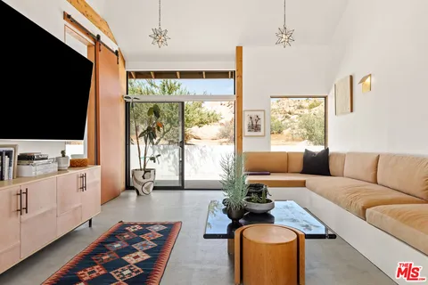 a living room with furniture fireplace and flat screen tv