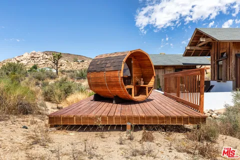 a roof deck with table and potted plants
