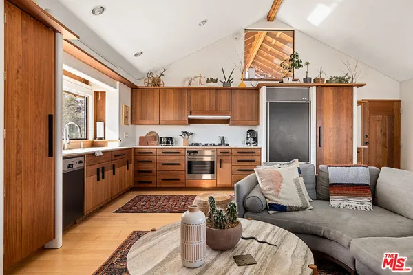 a kitchen with stainless steel appliances kitchen island granite countertop a refrigerator and a stove top oven