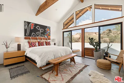 a bed room with a bed and glass door