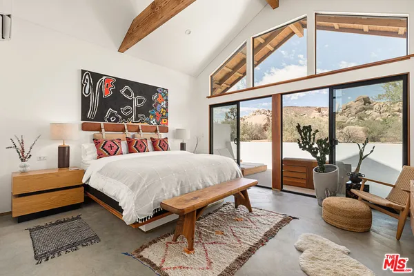 a bed room with a bed and glass door