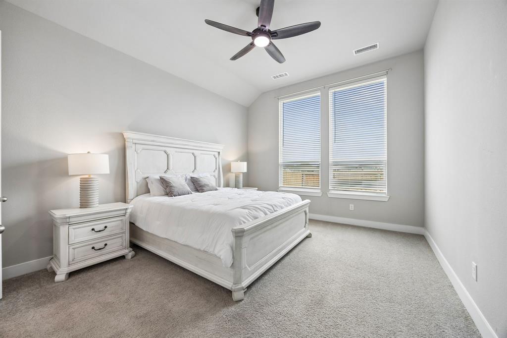 2430 Brightling Bend Forney, TX 75126 - Photo 11 of 37 Primary Bedroom featuring ceiling fan, light colored carpet, and lofted ceiling