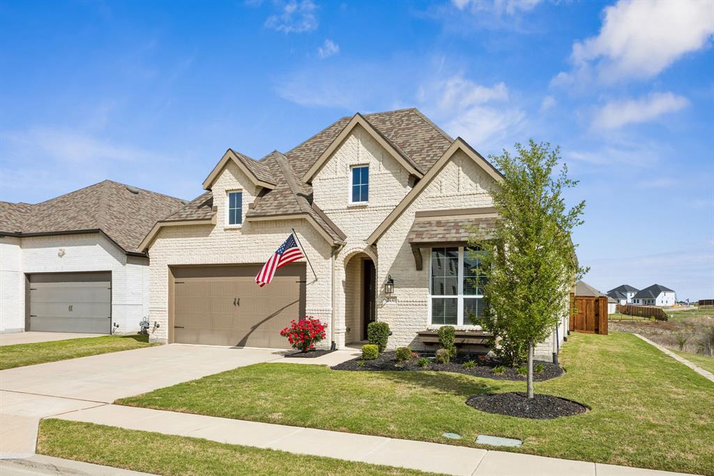2430 Brightling Bend Forney, TX 75126 - Photo 12 of 37 French provincial home featuring brick siding, a front yard, a shingled roof, and driveway