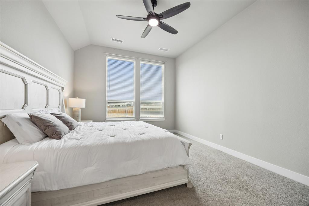 2430 Brightling Bend Forney, TX 75126 - Photo 23 of 37 Primary bedroom with vaulted ceiling and ceiling fan