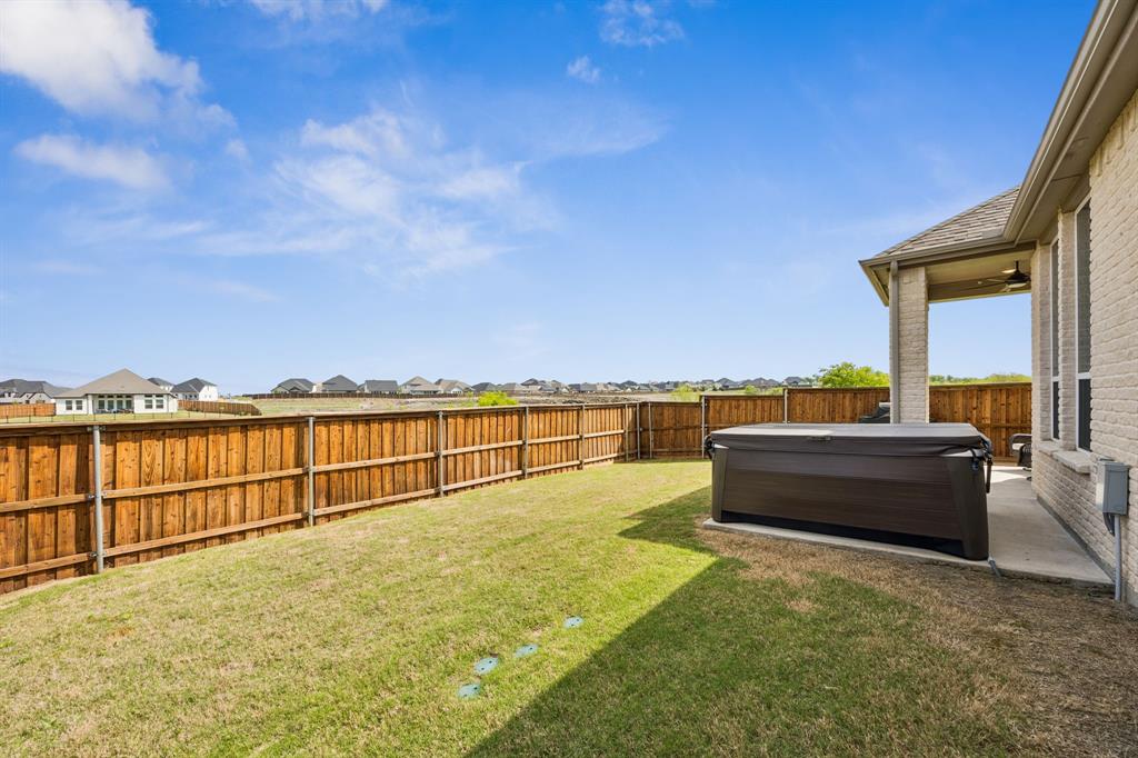 2430 Brightling Bend Forney, TX 75126 - Photo 32 of 37 Fenced backyard featuring a residential view, a hot tub, and a patio area