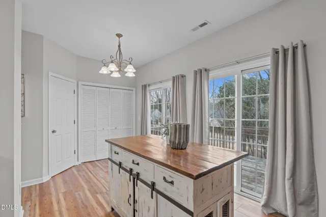 a view of a dining room with a table and chairs