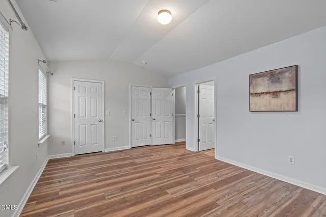 a view of a livingroom with wooden floor and window