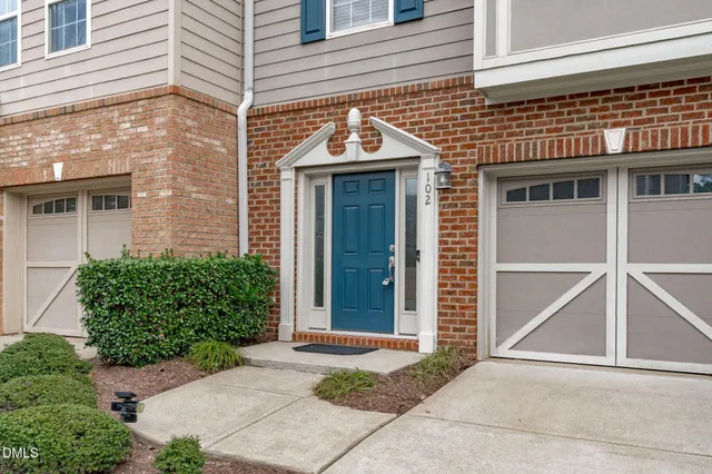 a front view of a house with a yard and seating space