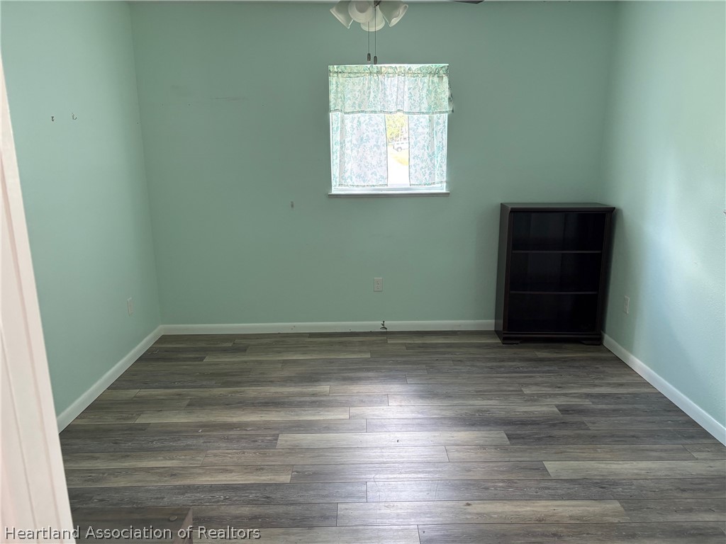 3913 Ferrari Drive Sebring, FL 33872 - Photo 15 of 20 an empty room with wooden floor and window