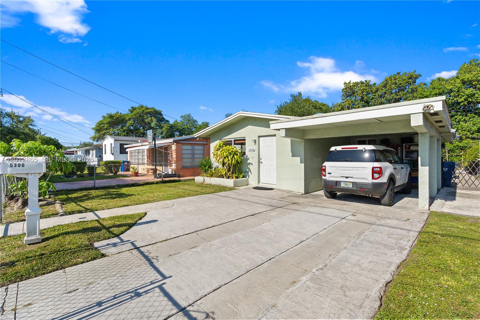 5300 Northwest 30th Place Miami, FL 33142 - Photo 2 of 35 a view of a car parked in front of a house
