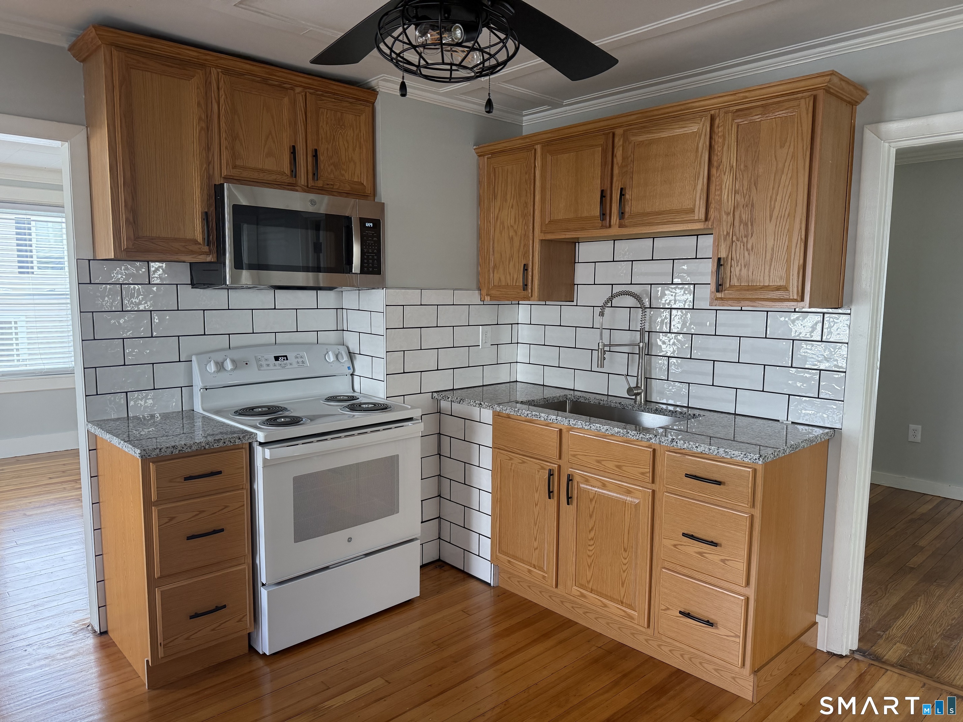 159 Hickory Street Norwich, CT 06360 - Photo 2 of 7 a kitchen with stainless steel appliances a stove sink and microwave