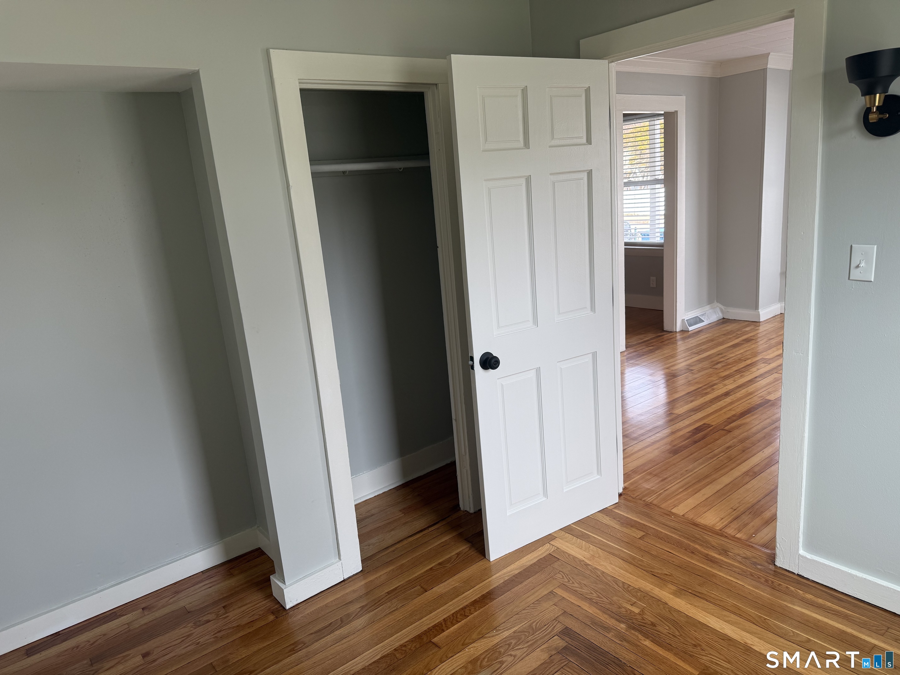 159 Hickory Street Norwich, CT 06360 - Photo 5 of 7 an empty room with wooden floor and closet