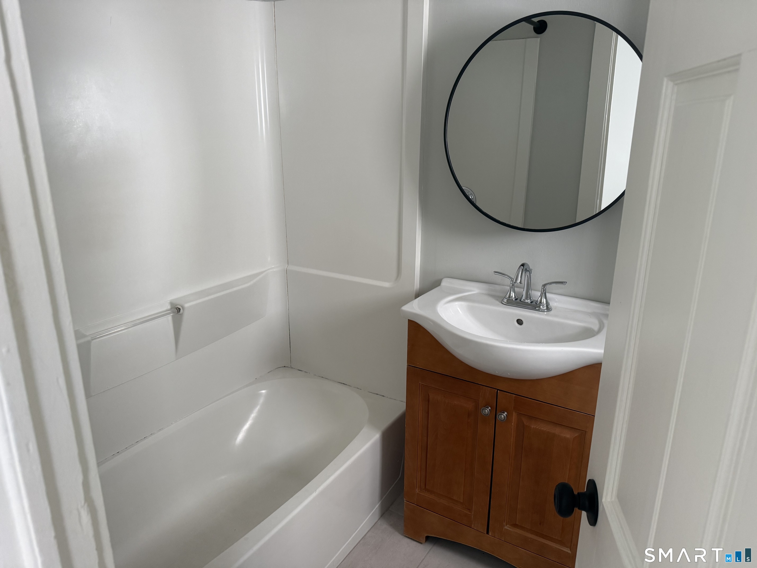 159 Hickory Street Norwich, CT 06360 - Photo 6 of 7 a bathroom with a sink and a mirror