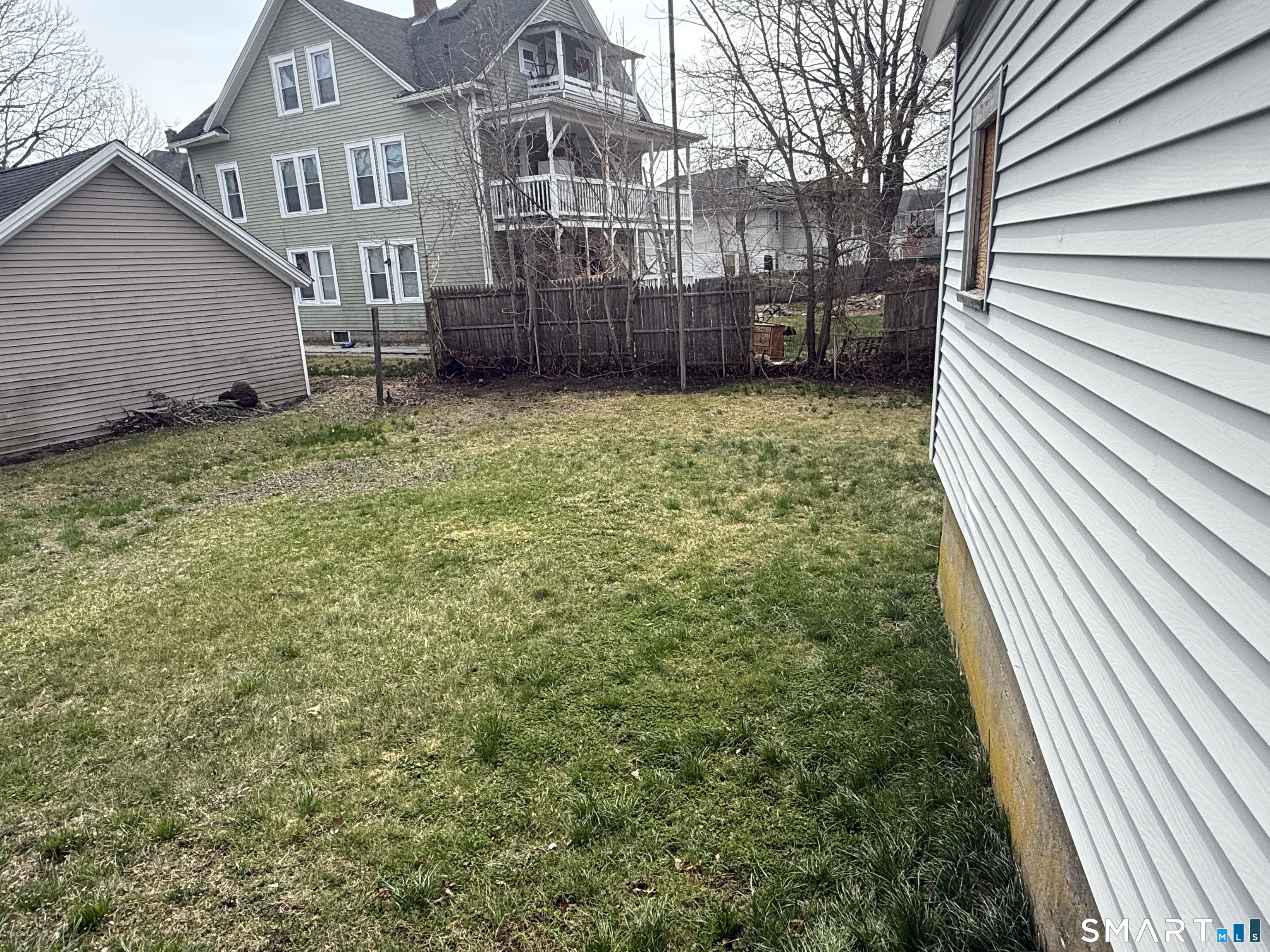 159 Hickory Street Norwich, CT 06360 - Photo 7 of 7 a view of a house with a yard and fence