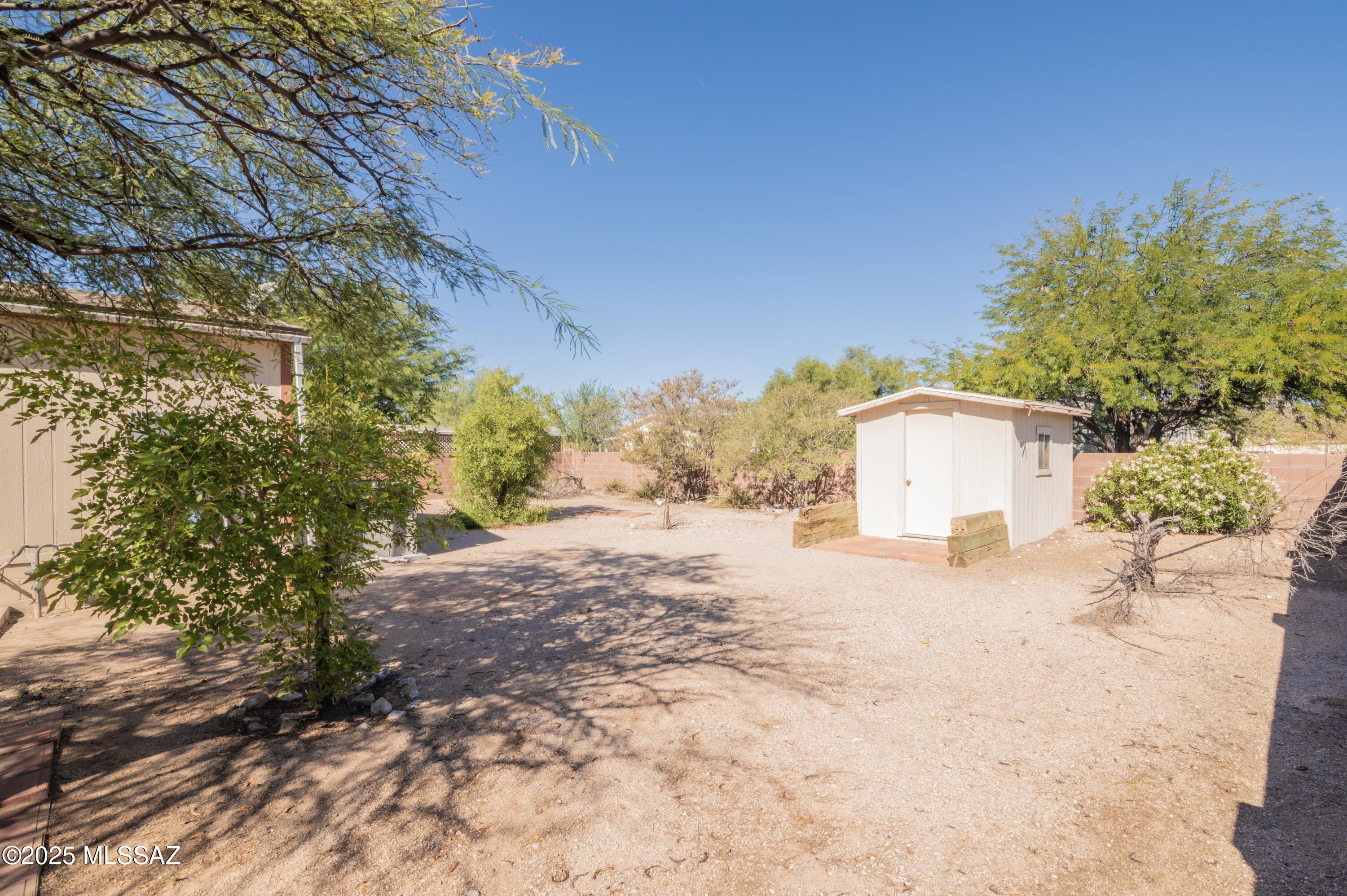 6205 East Rough Rock Drive Tucson, AZ 85756 - Photo 26 of 30 a tall yellow house with trees in front of it