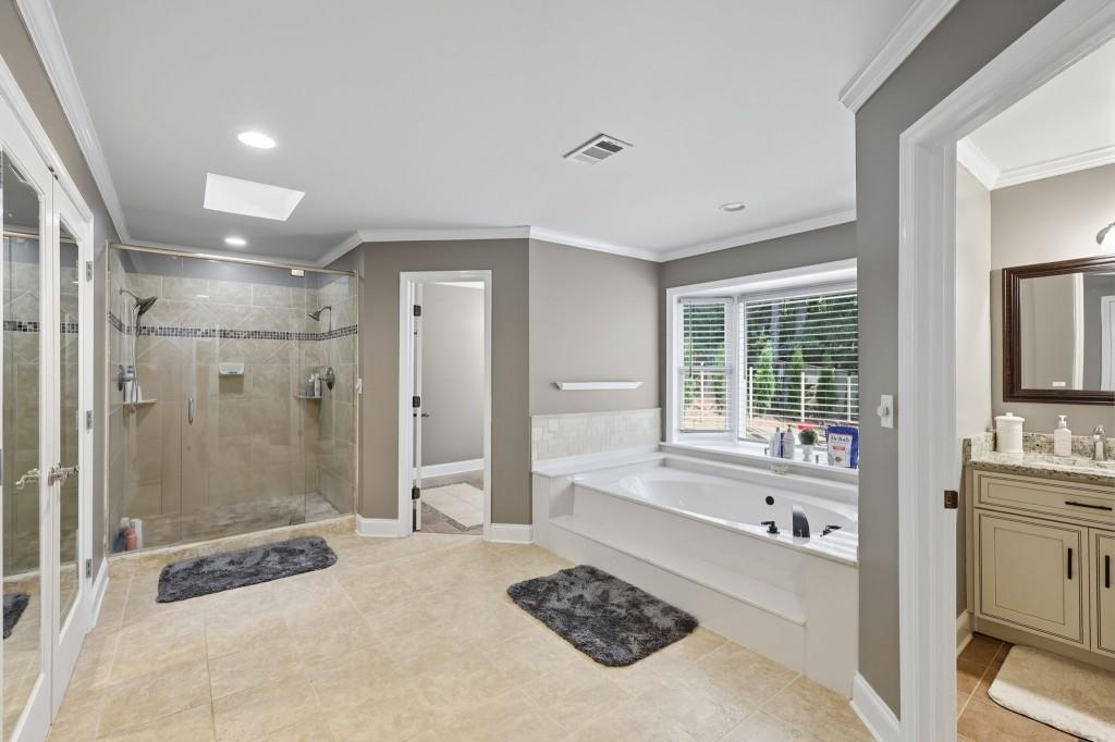 3810 Hardy Place Gainesville, GA 30506 - Photo 11 of 33 a bathroom with a tub sink vanity granite and shower