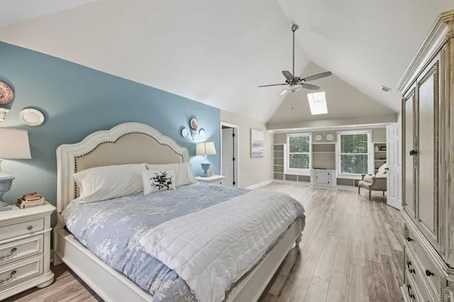 a bedroom with a large bed and a large window