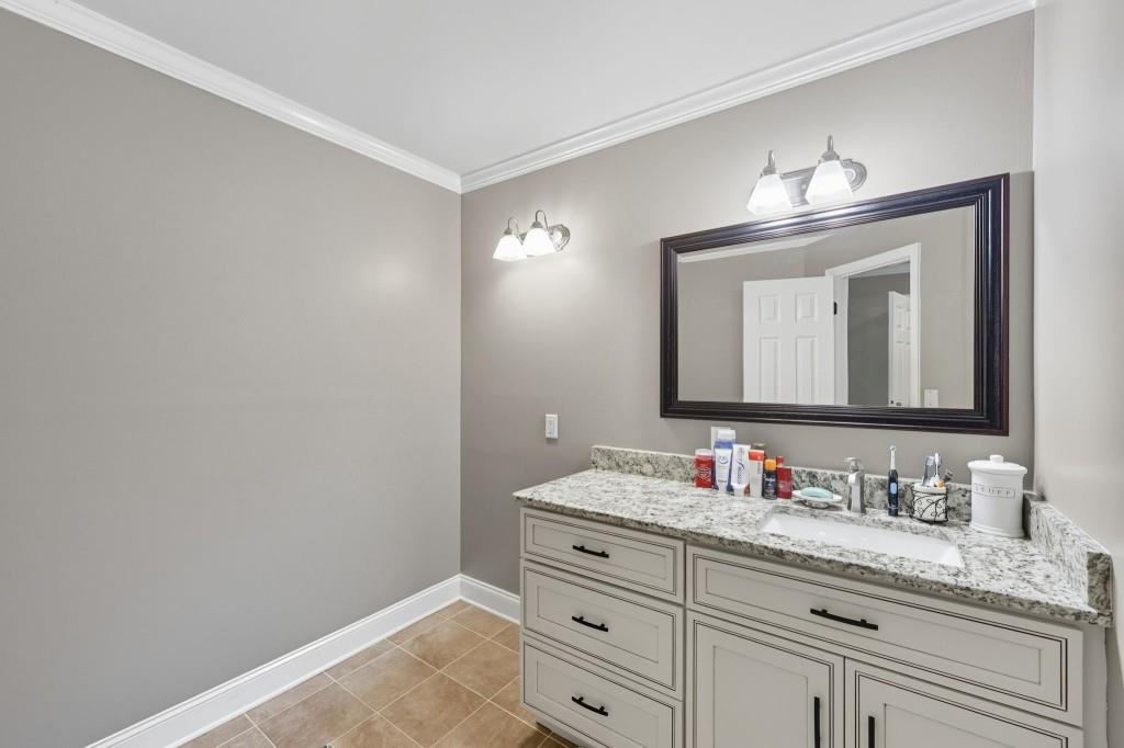 3810 Hardy Place Gainesville, GA 30506 - Photo 16 of 34 a bathroom with a granite countertop sink vanity and mirror