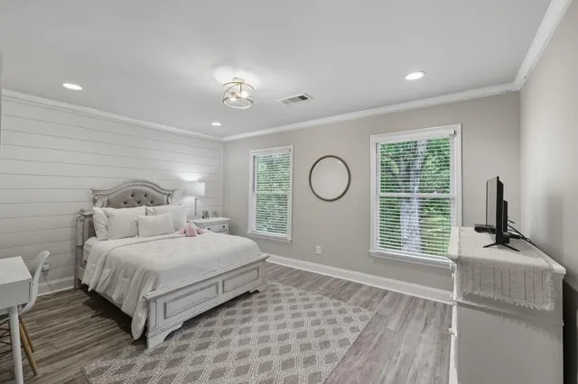 a bedroom with a large bed and a window