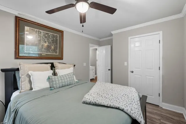 a bedroom with a large bed and a chandelier
