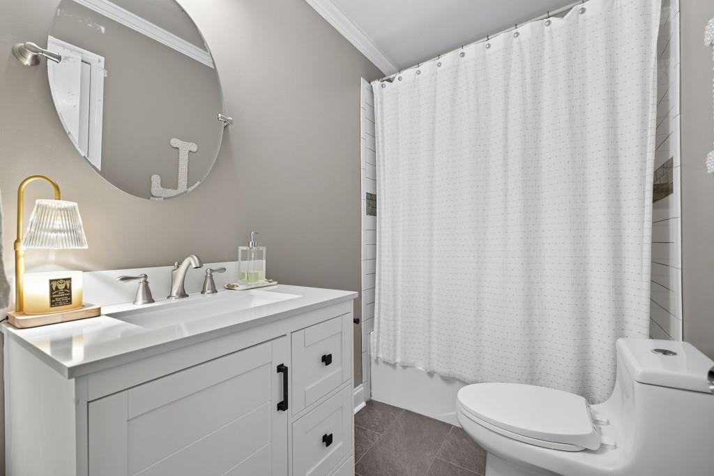 3810 Hardy Place Gainesville, GA 30506 - Photo 22 of 34 a bathroom with a sink a toilet and shower curtain