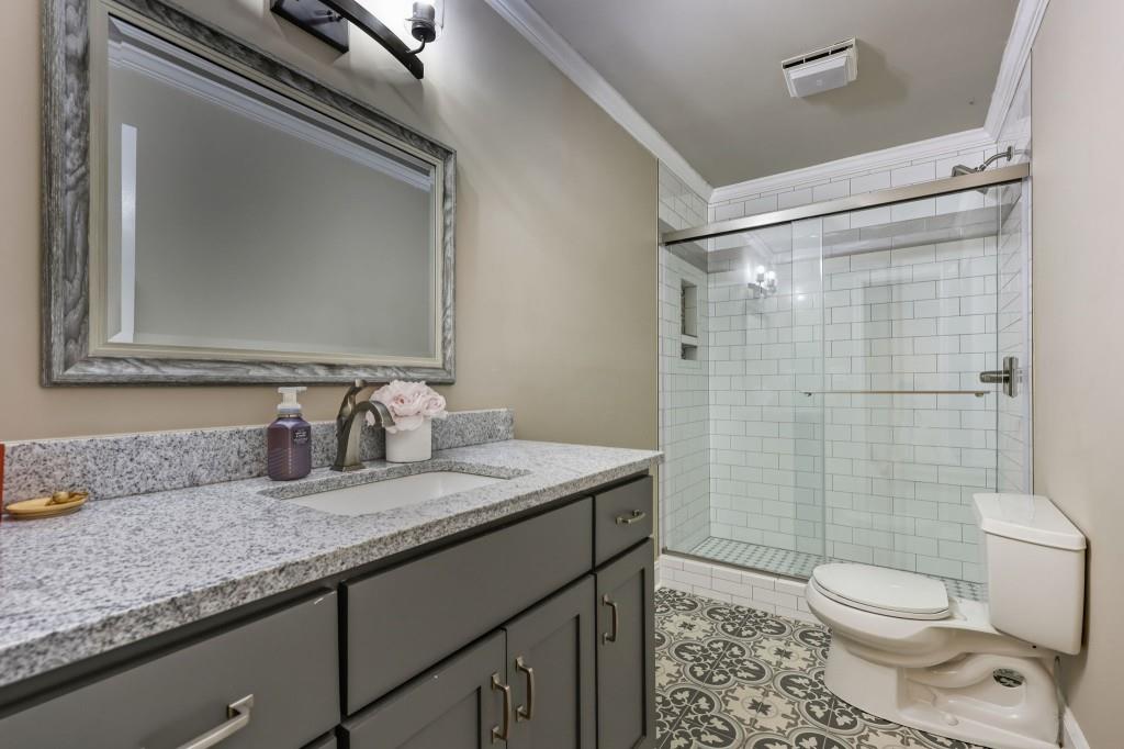 3810 Hardy Place Gainesville, GA 30506 - Photo 24 of 34 a bathroom with a granite countertop sink toilet and shower