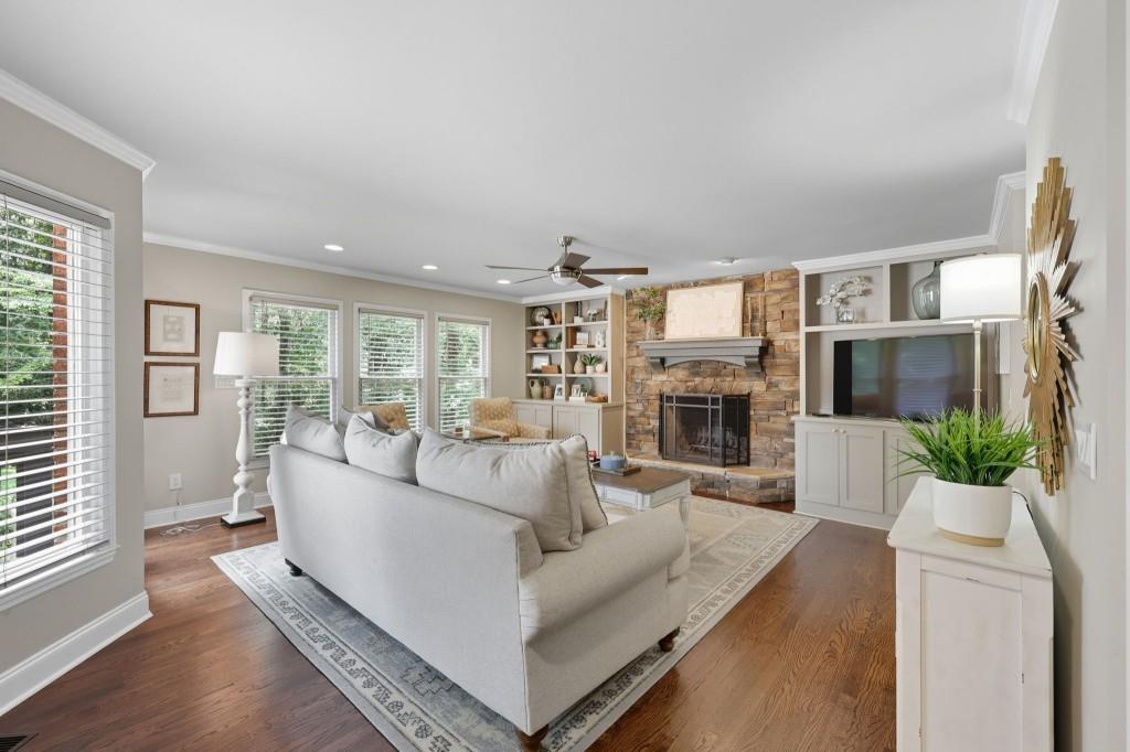 3810 Hardy Place Gainesville, GA 30506 - Photo 6 of 34 a living room with furniture large windows and a fireplace