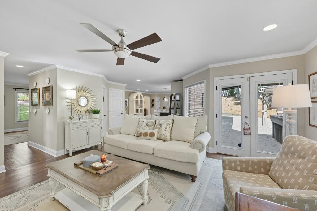 3810 Hardy Place Gainesville, GA 30506 - Photo 6 of 33 a living room with furniture a rug and a chandelier
