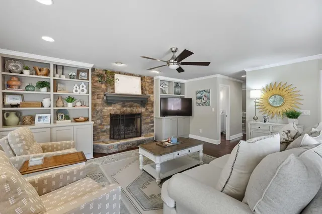 a living room with furniture and a fireplace