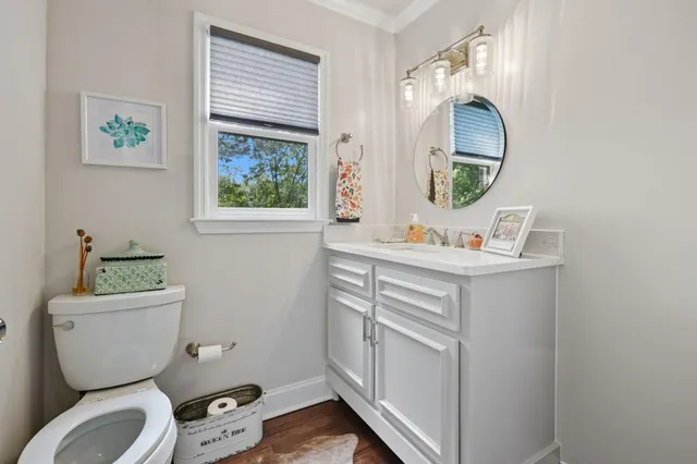 a bathroom with a toilet sink and mirror