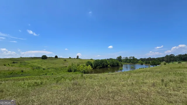 a view of a lake and green valley