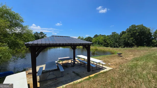 a view of a lake with couches and wooden floor