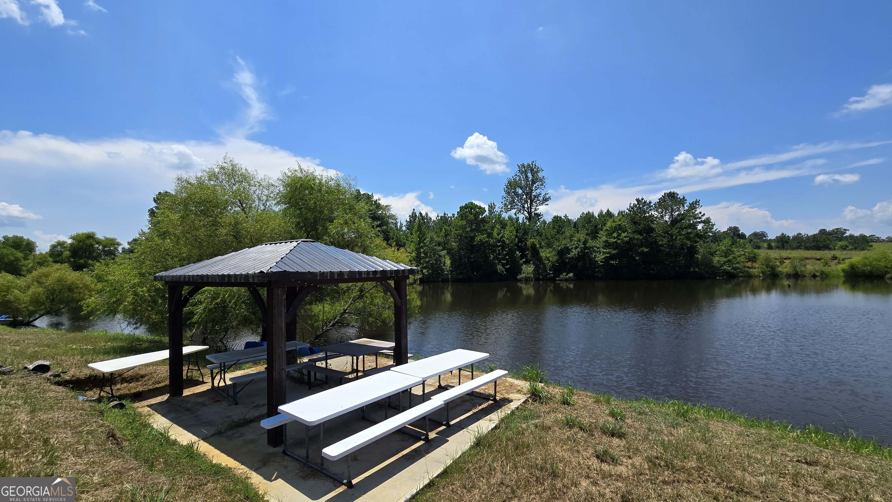 361 Allen Road Musella, GA 31066 - Photo 24 of 41 a view of a lake with couches and wooden floor