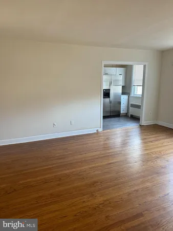 a view of a room with wooden floor