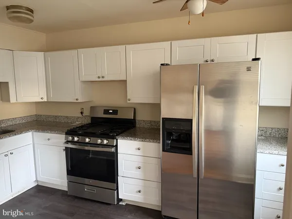 a kitchen with cabinets appliances and a counter space