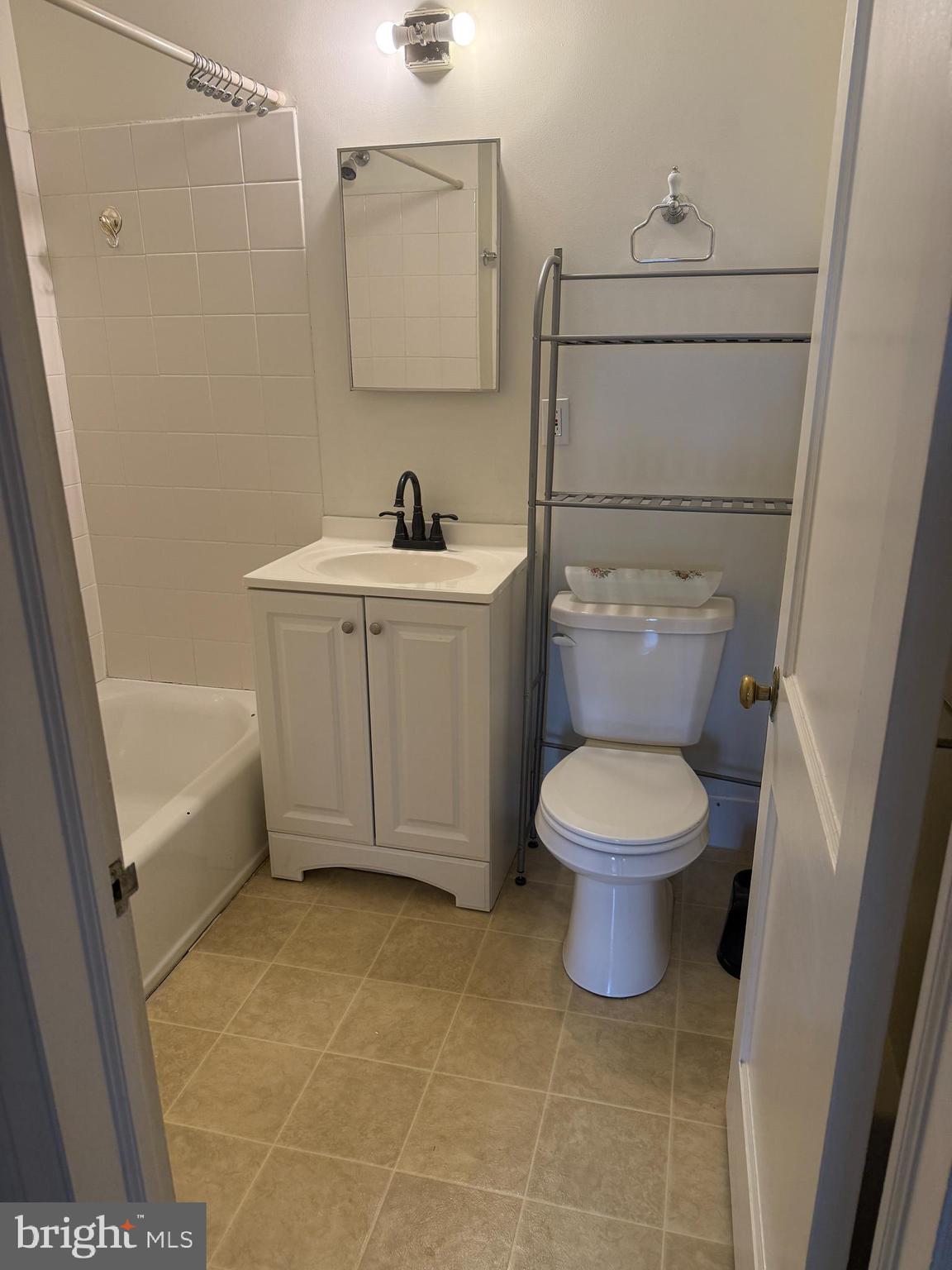 112 Fairfield Lane, Unit 1 Wayne, PA 19087 - Photo 7 of 9 a bathroom with a toilet sink and mirror