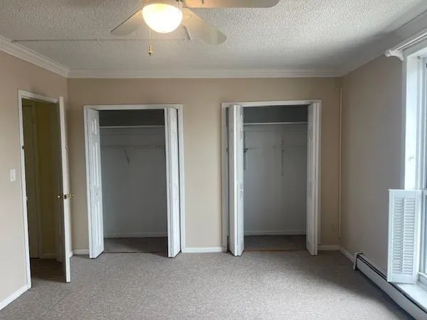 an empty room with closet and a bathroom