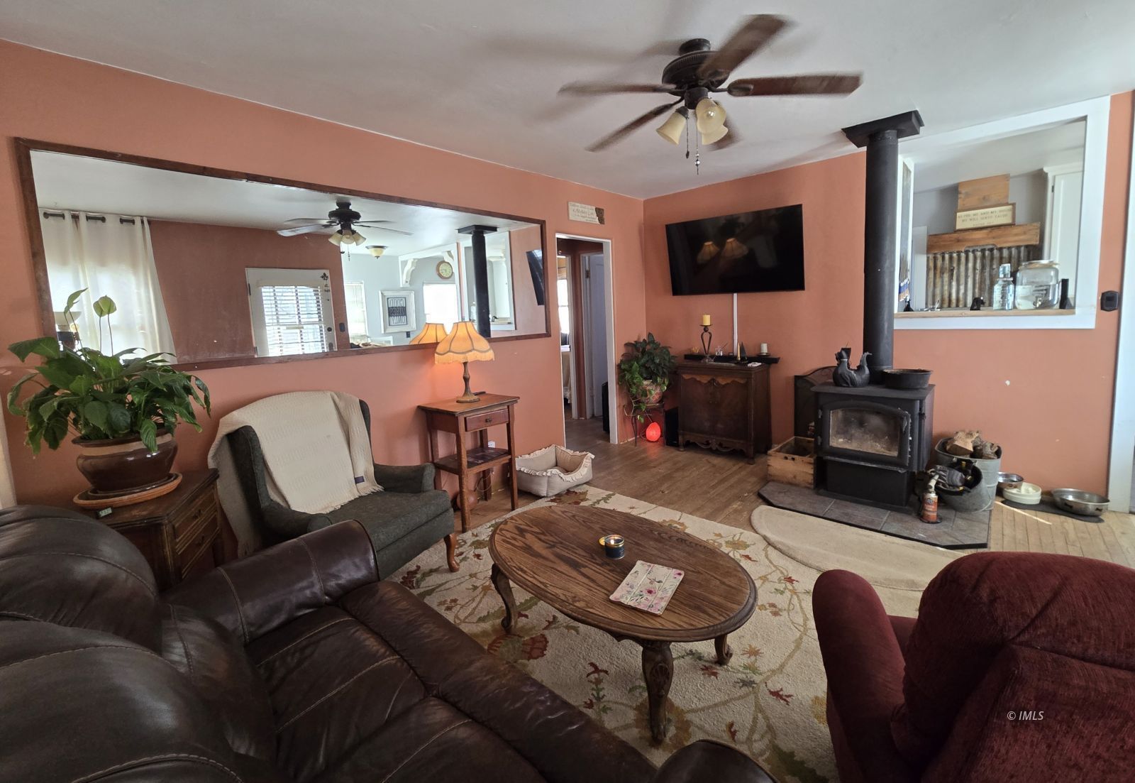 625 East Inyo Street Lone Pine, CA 93545 - Photo 4 of 16 a living room with furniture a flat screen tv and a chandelier