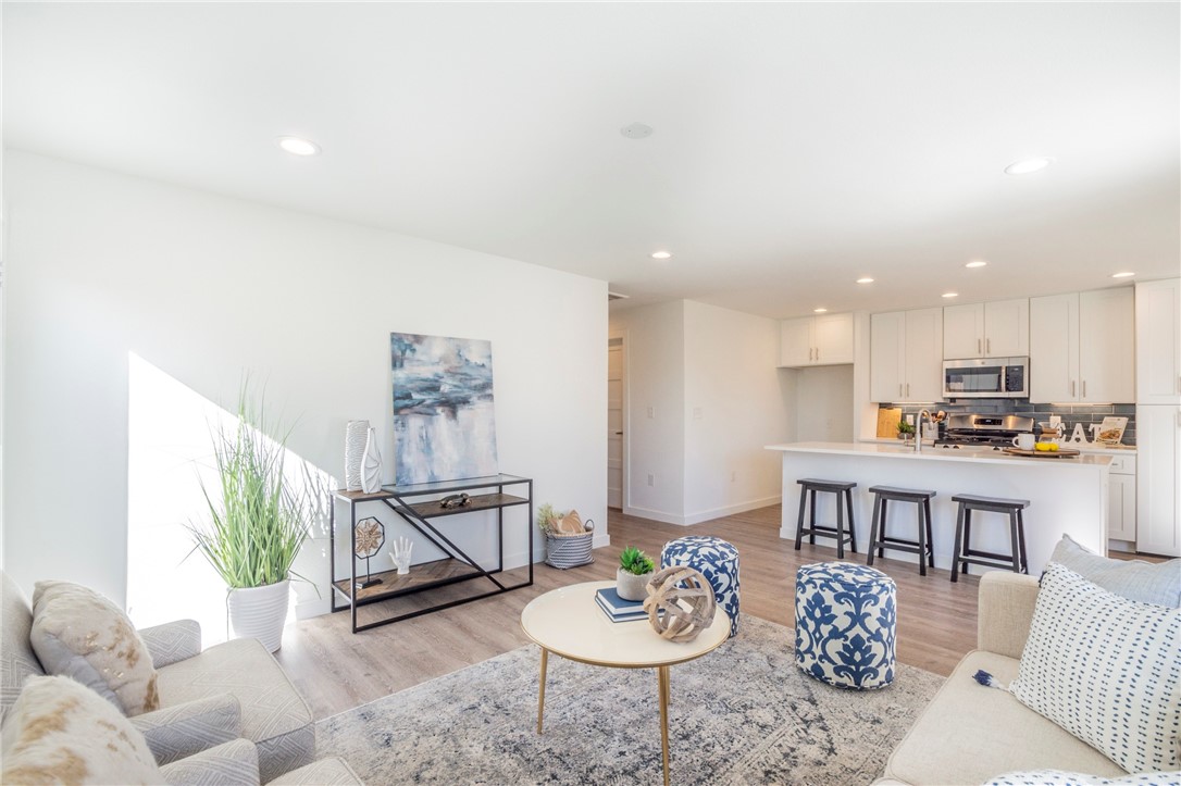 a living room with furniture and kitchen view