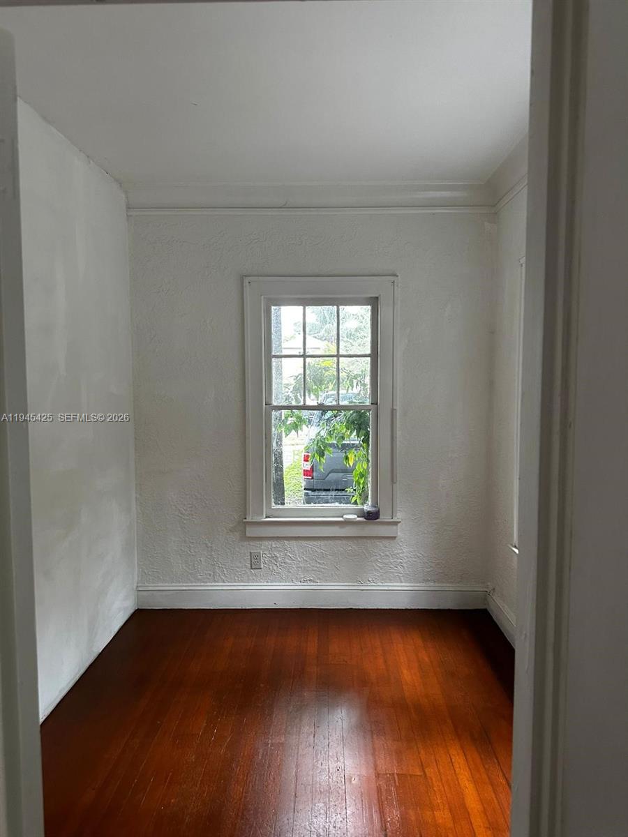 4116 Southwest 13th Terrace Miami, FL 33134 - Photo 3 of 8 an empty room with wooden floor and windows